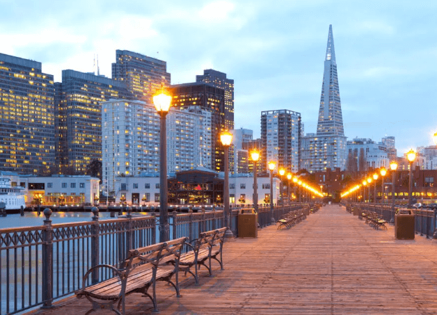  City skyline of San Francisco at night with illuminated buildings and twinkling lights