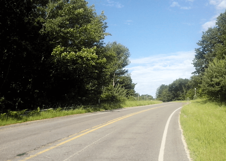 Scenic Hart Montague Bike Trail winding through lush forests and charming small towns in Michigan